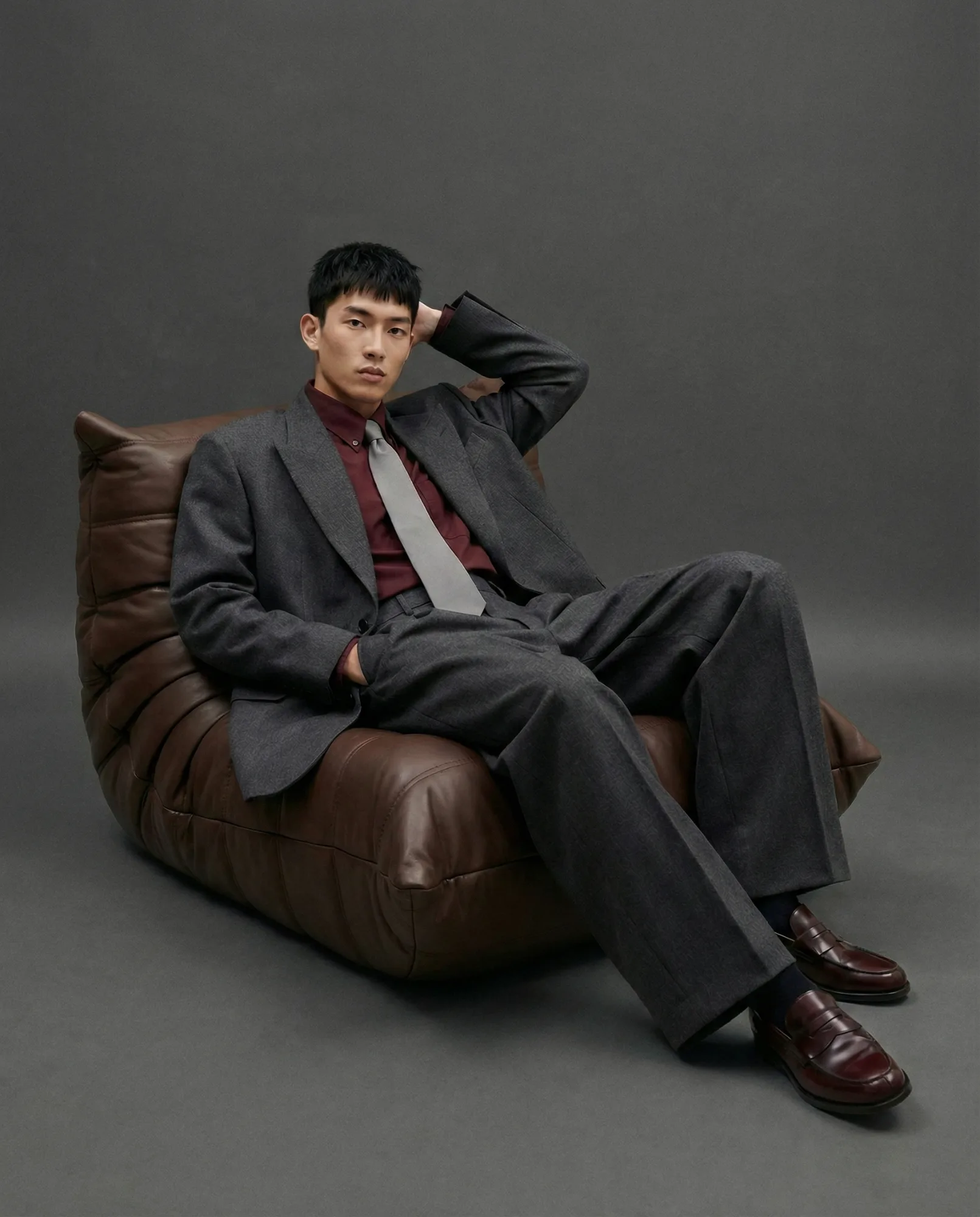 Immagine e-commerce menswear generata con AI con modello in completo elegante su sfondo scuro editoriale